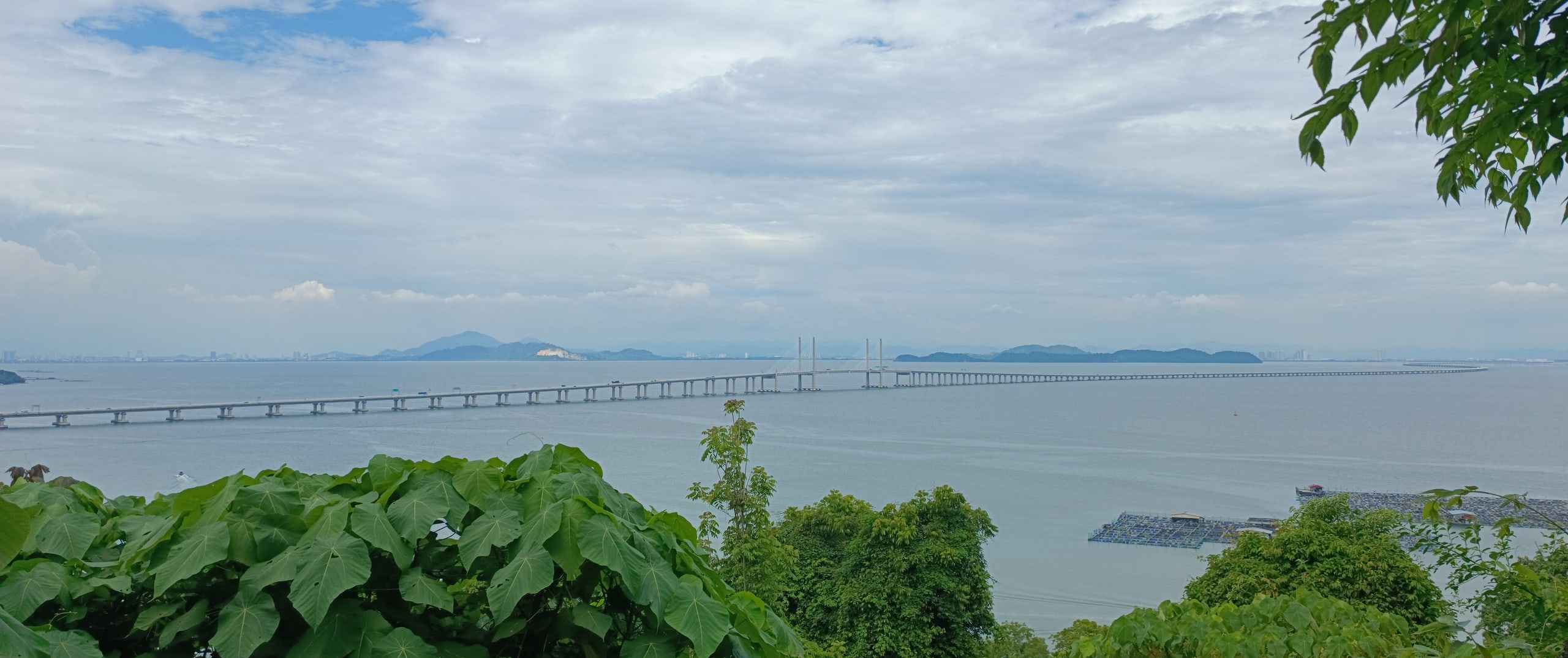 The Second Penang Bridge crossing the strait, seen from the wooded hill of the Penang War Museum at Batu Maung